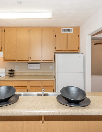 Apartment Kitchen Featuring Cabinetry & Countertops