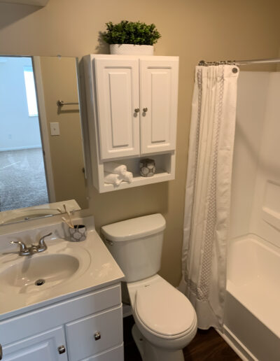 Functional Bathroom With Sink, Toilet & Shower Combination